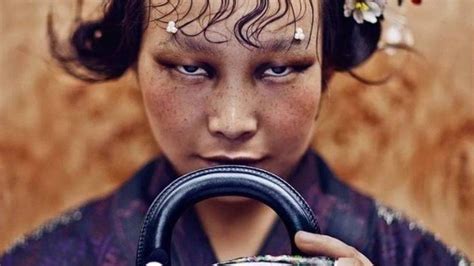 china: photographer sorry for 'small eyes' dior picture